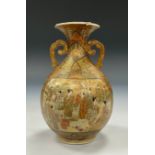 A Japanese Satsuma twin-handled vase, decorated with traditional intricate patterns typically