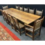 An Oak refectory dining table, by Nigel Griffiths, and ten dining chairs and two carver chairs