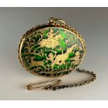 A 19th century Indian Pratapgarh thewa work oval brooch, decorated with hunters on horseback and
