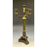 A Regency period bronze and ormolu mounted four light candelabra, gadrooned urnular sconces,