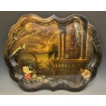 A large post-Regency toleware shaped serpentine tray, painted in polychrome with Italianate ruins