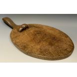 Robert Thompson, Mouseman of Kilburn - an oak cheese board, lightly adzed overall, carved mouse