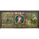 An Arts and Crafts stained glass panel, the central circular pane with a depiction of Flora, Roman
