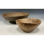An 18th century burr oak bowl, 22cm diameter; a French turned sycamore bowl on pedestal, 40cm