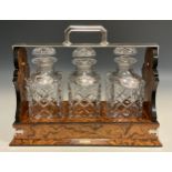 A Burr Walnut Three-Decanter Tantalus, by George Betjemann & sons, silver-plated handle, locking