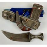 A Middle Eastern silver coloured metal mounted jambiya dagger, 20cm curved blade, horn hilt, hide