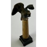 A 19th century parcel-gilt bronze and Sienna marble pocket watch stand, as an eagle atop a column,