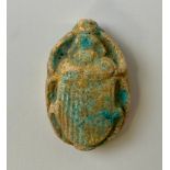 An Egyptian faience scarab beetle, traces of turquoise glaze, 5cm long