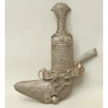 A Middle Eastern silver coloured metal mounted jambiya dagger, 15cm curved blade, the scabbard and