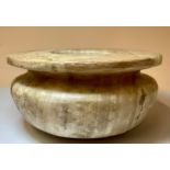 An alabaster vessel, in the Egyptian manner, 9.5cm high