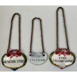 A pair of 19th century French enamel wine labels, Benedictine and Fine Champagne, 5cm wide; another,