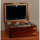 A George IV brass bound mahogany dressing case, hinged cover enclosing a fitted interior with lift-