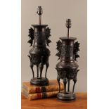 A pair of Japanese brown patinated bronze vases, cast in the Archaic taste with birds, flowers and
