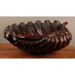Interior decoration - a carved mahogany shell shaped bowl, 41.5cm wide.