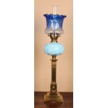 A Victorian brass oil lamp, graduated blue glass frill top shade, Young's Screw No.2 burner, blue