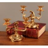 A pair of Louis XV style French ormolu two branch candelabra, with scrolling foliate arms and