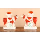 A near pair of 19th century Staffordshire flatback advertising spill vases, each modelled as a cow