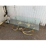 Heavy solid brass based coffee table in the form of hands playing a piano with glass top. H43cm