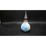 Moorcroft perfume bottle featuring a blue lily design on a white background with a metal stopper,