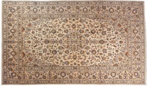 A Kashan carpet, the ivory field with a central beige shape oval pole medallion,