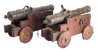A pair of bronze and oak mounted models of cannon,