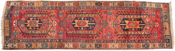 A Kurdish runner, the shaded rose field with triple hooked hexagonal medallions,