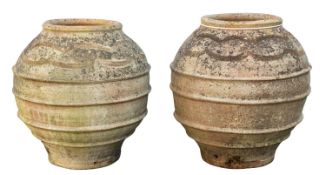 A pair of terracotta garden pots, 20th century; of ribbed ovoid form,