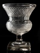 A heavy cut glass vase, of thistle shaped form, on square base, 26cm high.