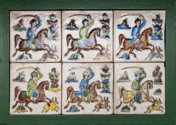 A Qajar tile panel, early 20th century of six polychrome moulded tiles depicting mounted huntsmen,