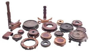 A group of eighteen Chinese carved wooden urn and plate stands, various ages and decoration.