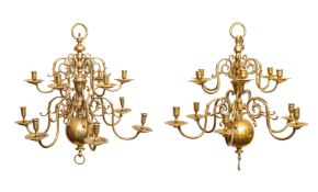 A matched pair of Dutch brass twelve light chandeliers,