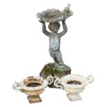 A lead figural bird bath cast as a standing putto,