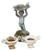A lead figural bird bath cast as a standing putto,