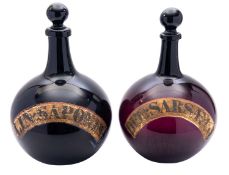 A pair of amethyst glass Apothocary bottles,