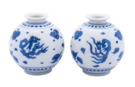 A pair of Chinese blue and white 'dragon' jarlets each painted with dragons and cloud scrolls,