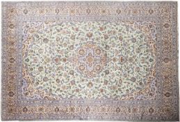 A Kashan carpet, the pistachio field with a central beige and pastel blue cartouche pole medallion,