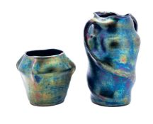 Two Heliosine Austrian iridescent pottery vases, one of wrythen form with twin handles and oval rim,