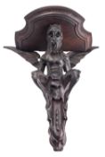 A carved and stained walnut wall bracket, probably Italian,