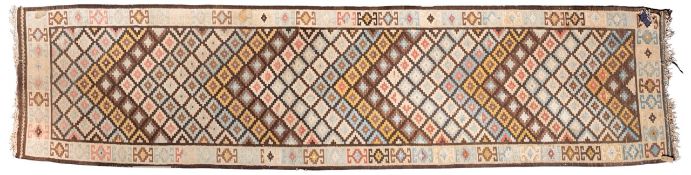 A Kelim runner, the stepped lozenge chevron design field with stepped cruciform medallions,