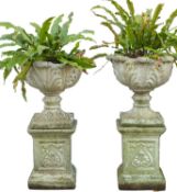 A pair of stone composition planters of trumpet form,