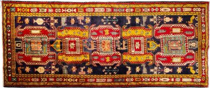 An Ardebil Kelle, the indigo field with a row of five hooked and shaped geometric medallions,