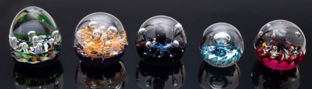 A group of eighteen Caithness and other Scottish glass paperweights of varying shape and decoration,