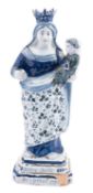 A Dutch delft figure of the Madonna and Child, under blue and green decoration,