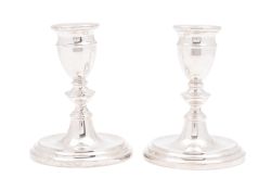A pair of modern silver candlesticks, circular form, with knopped stems,
