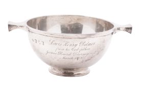 An Edwardian Scottish silver quaich, of plain, conventional form and the base inset with a sixpence,