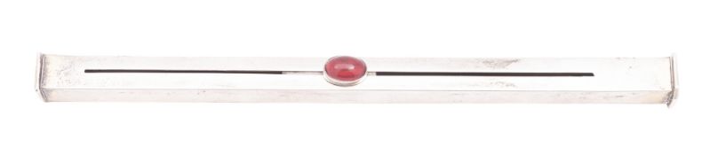 An Edwardian parcel-gilt sealing wax holder, square tubular form, with a red glass cabachon slider,