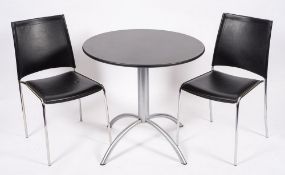 A bistro table and twin chairs, modern;