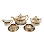 A William Adams porcelain tea service painted with landscape vignettes within blue and gilt borders,