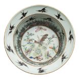 A Chinese porcelain basin the interior enamelled with butterflies and flowers