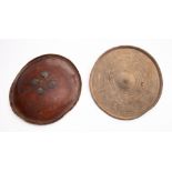 A 19th century Indo-Persian hide dhal, with brass applique, 36cm diameter, one other hide dhal,